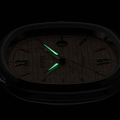 The hands on the FIYTA Tempered rose-dial watch glowing green against a dark background. (GA850028.WOK)