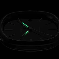 The hands on the FIYTA Tempered black-dial watch glowing green against a dark background. (GA850029.WBB)